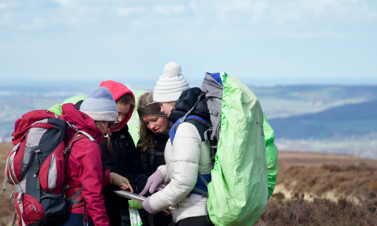 DofE Silver students on the moors looking at their map planning navigation 