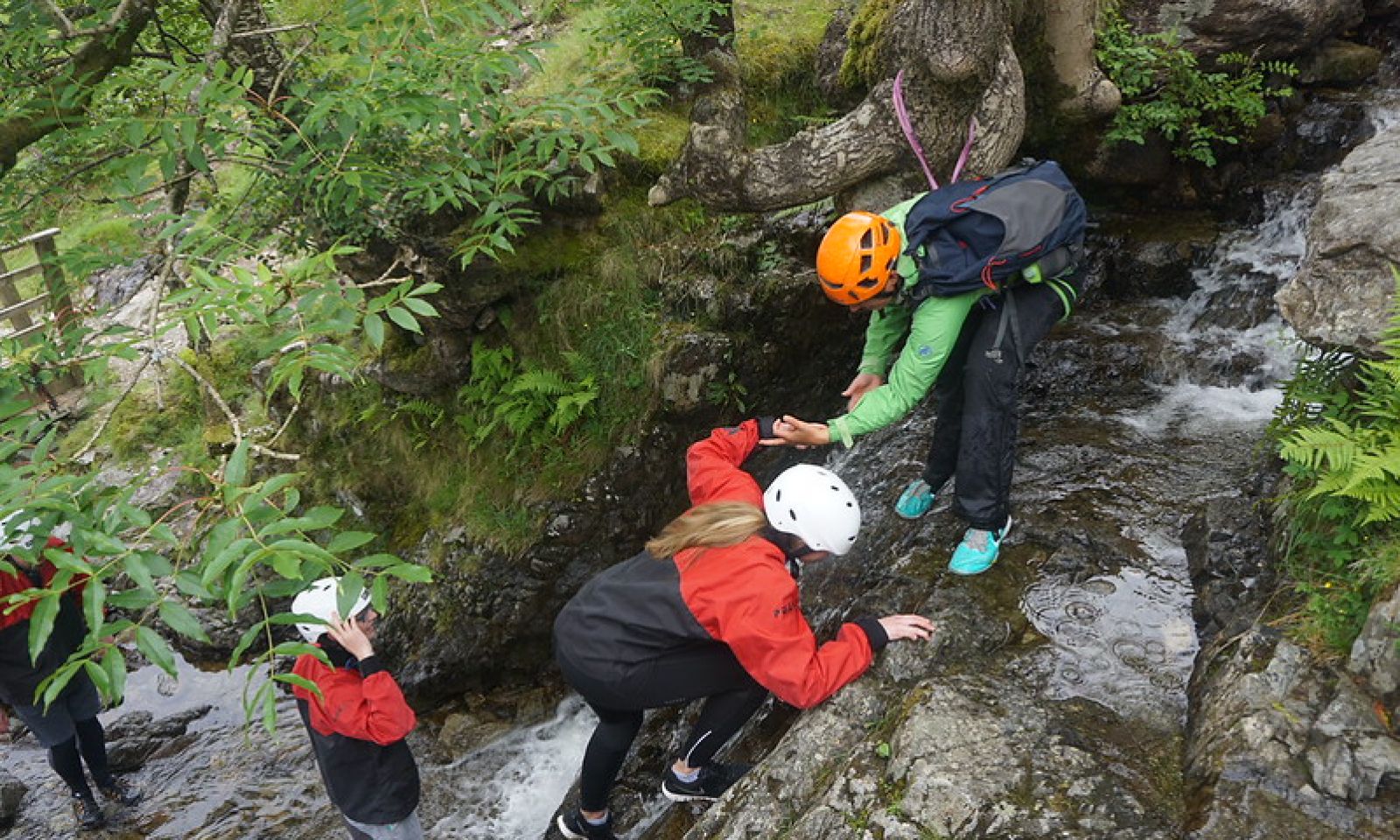 Girl climbing a rope net on the Via Ferrata at Honister Slate Mine.