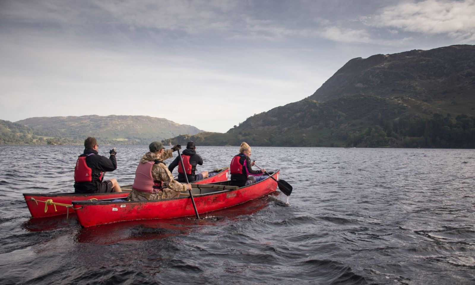 A group in canoes on Ullswater during a challenge event.