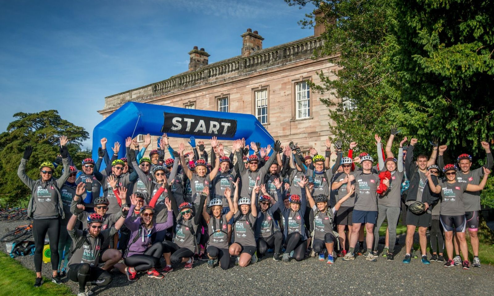Group standing under the start arch ready to begin a challenge event.