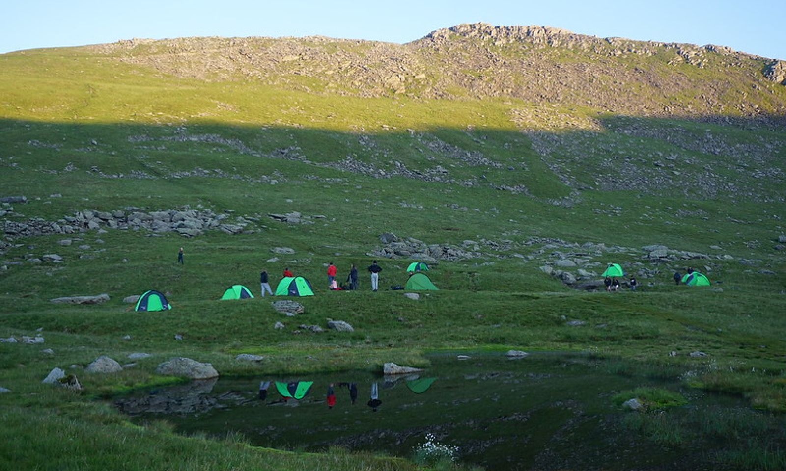Tents wild camping around a tarn