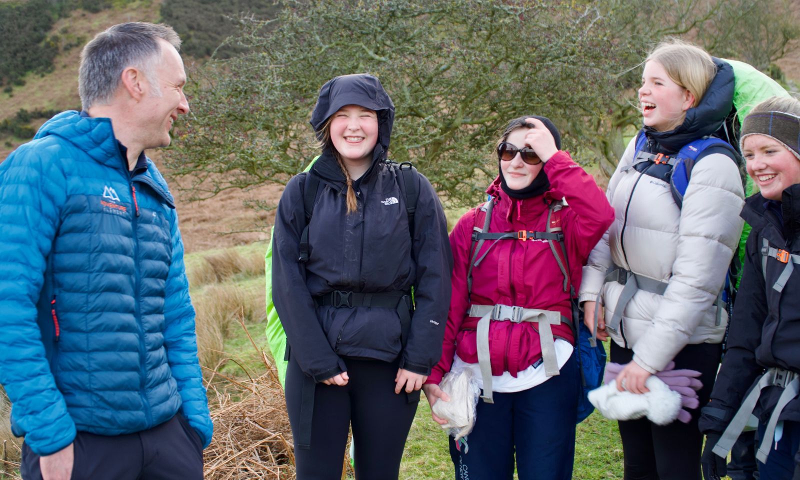 DofE team on walking expedition chatting with The Adventure Element instructor