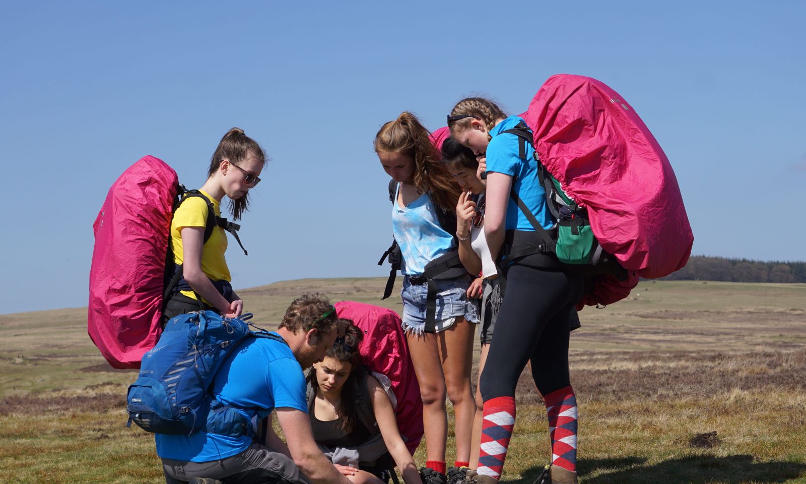 Checking navigation with a Duke of Edinburgh expedition group in the moors