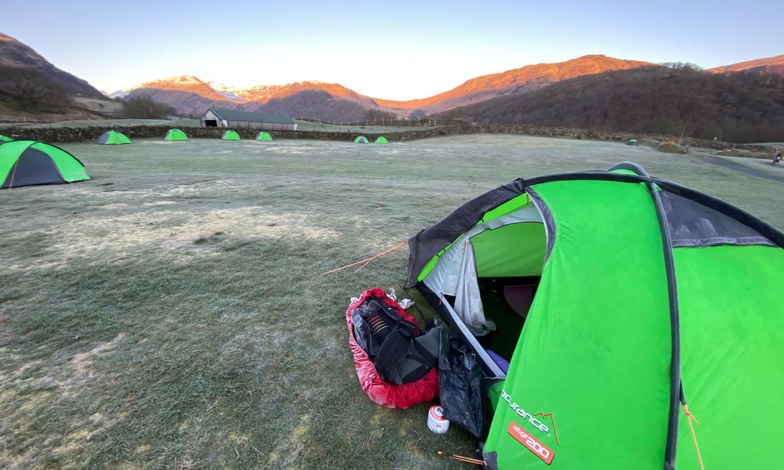 DofE Gold expedition tents pitched in the valley with surrounding mountain views