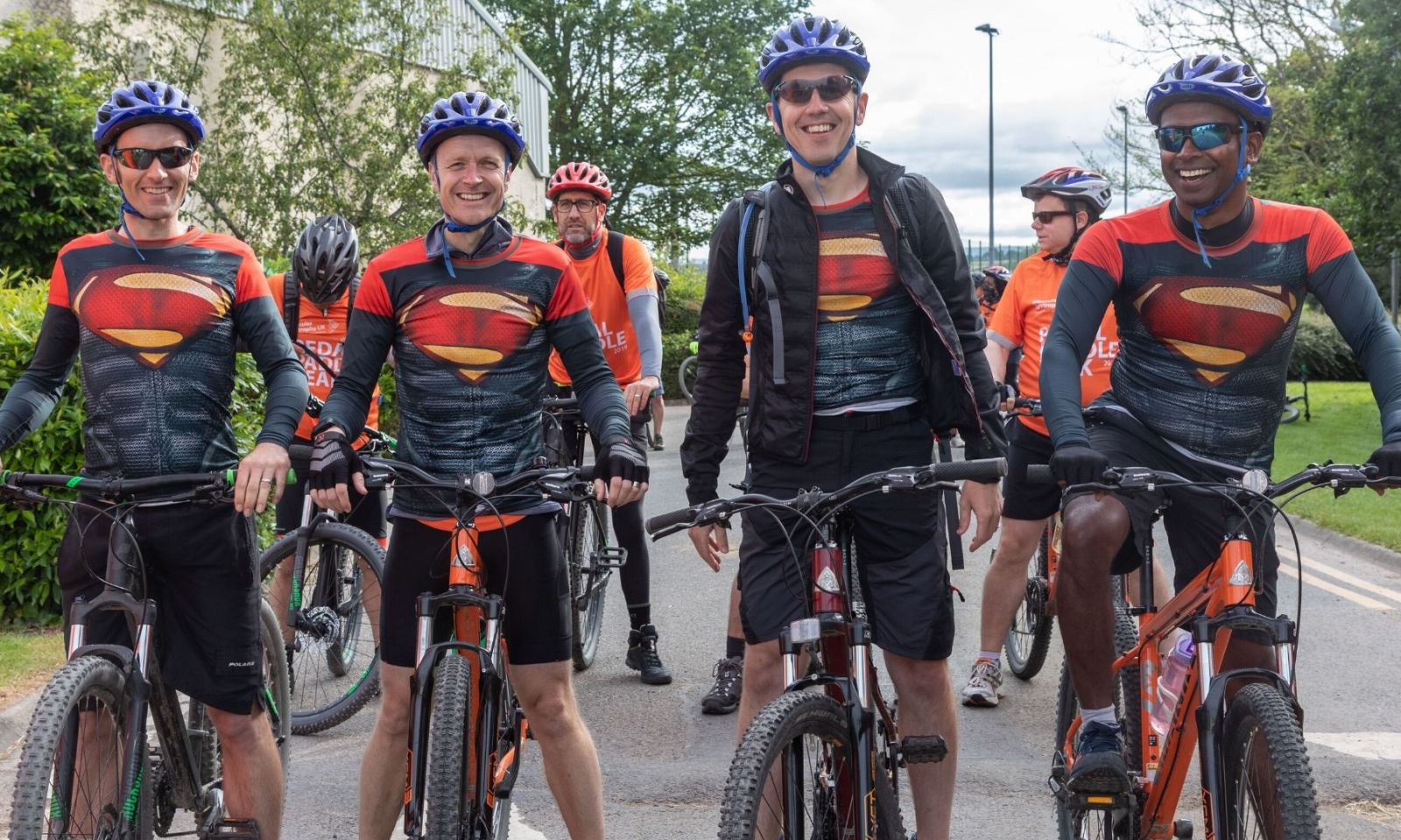 4 male cyclist with their bikes on the start line ready for their event.
