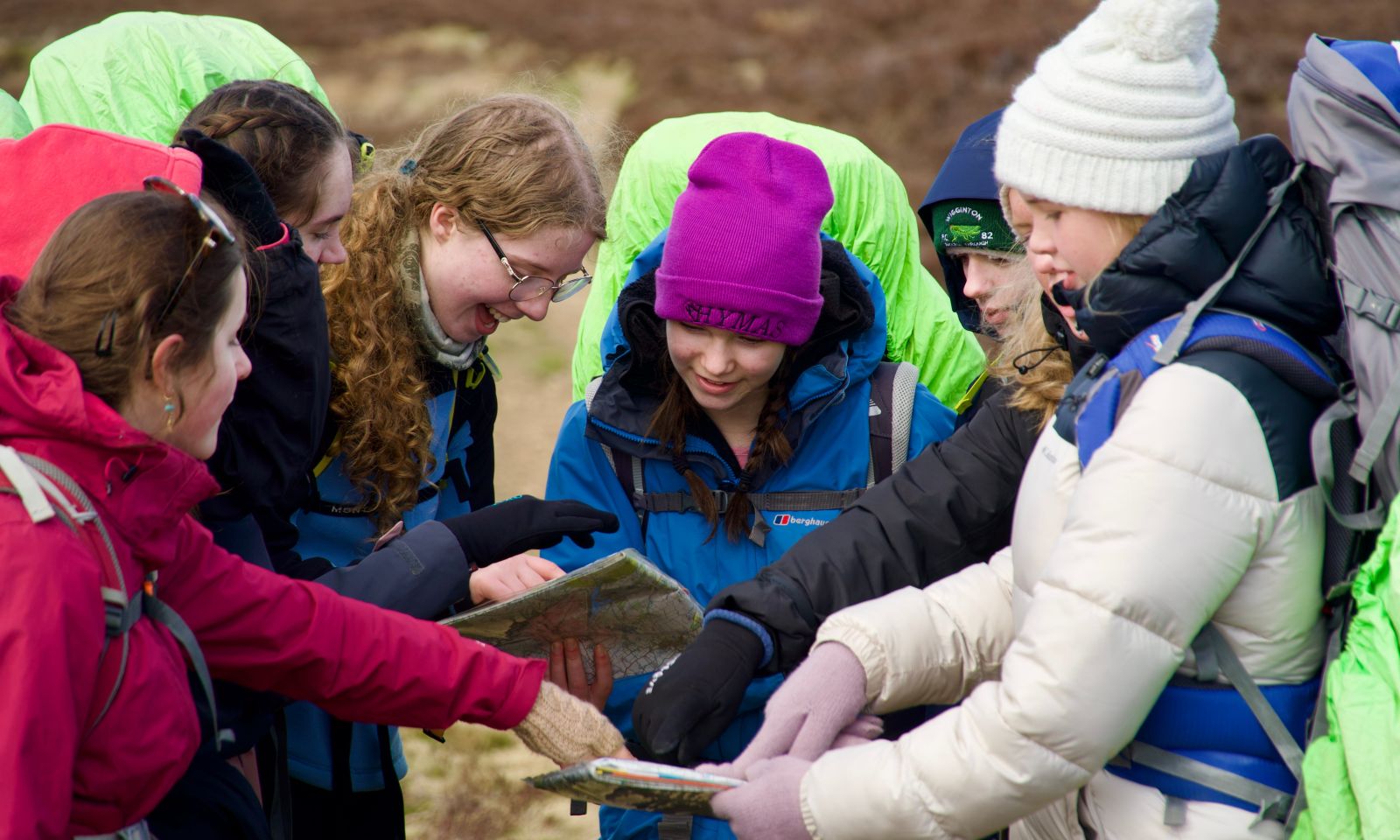 DofE expedition group working together as a team to look at the maps and work out the route