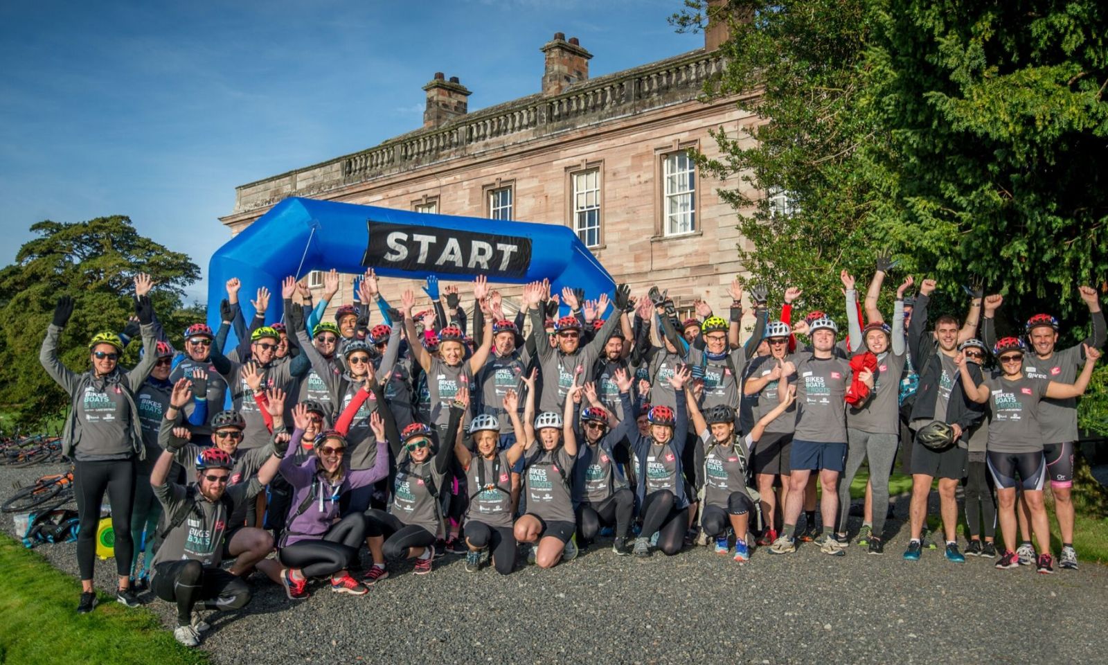 Group standing under the start arch ready for a challenge event.