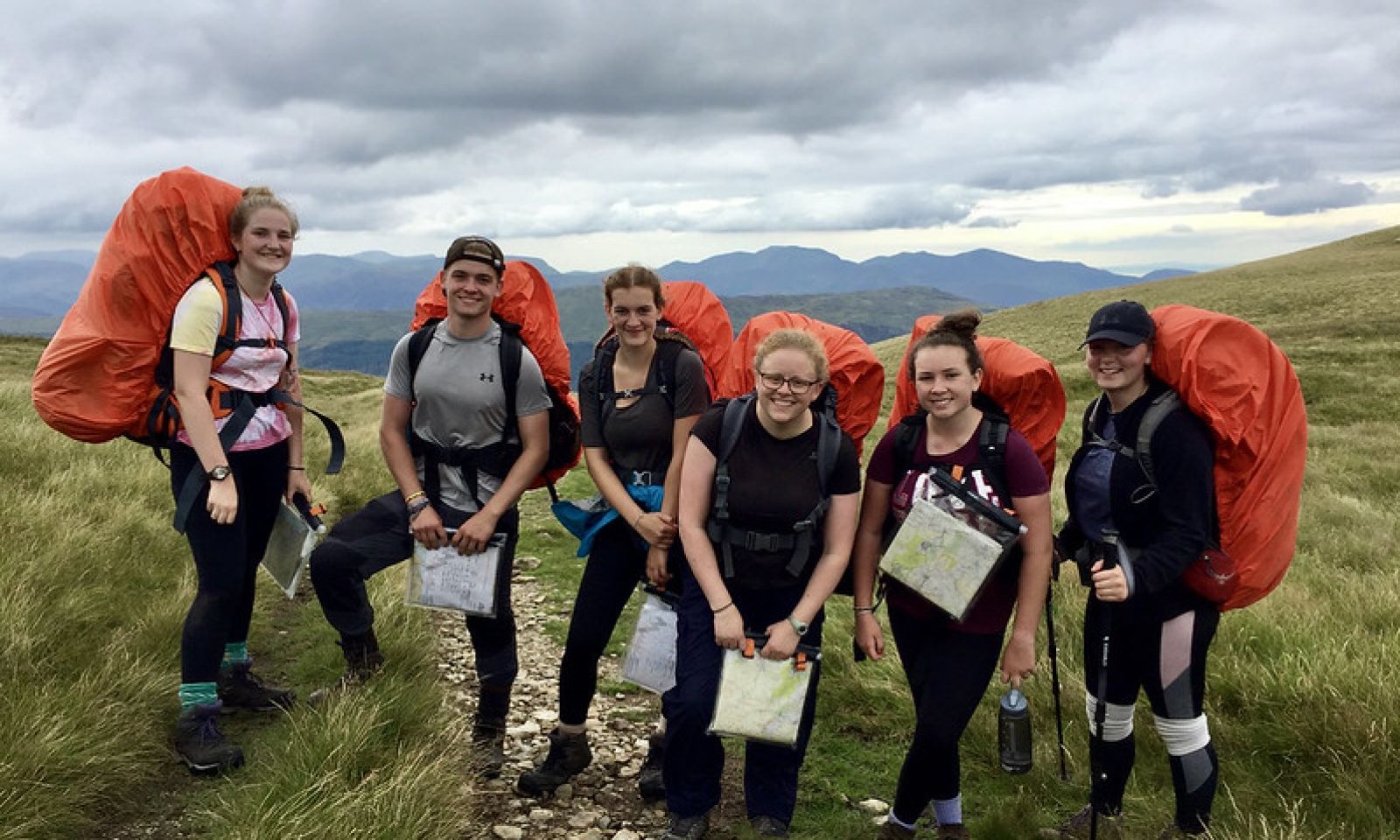DofE group in the hills with their coloured rucksack covers