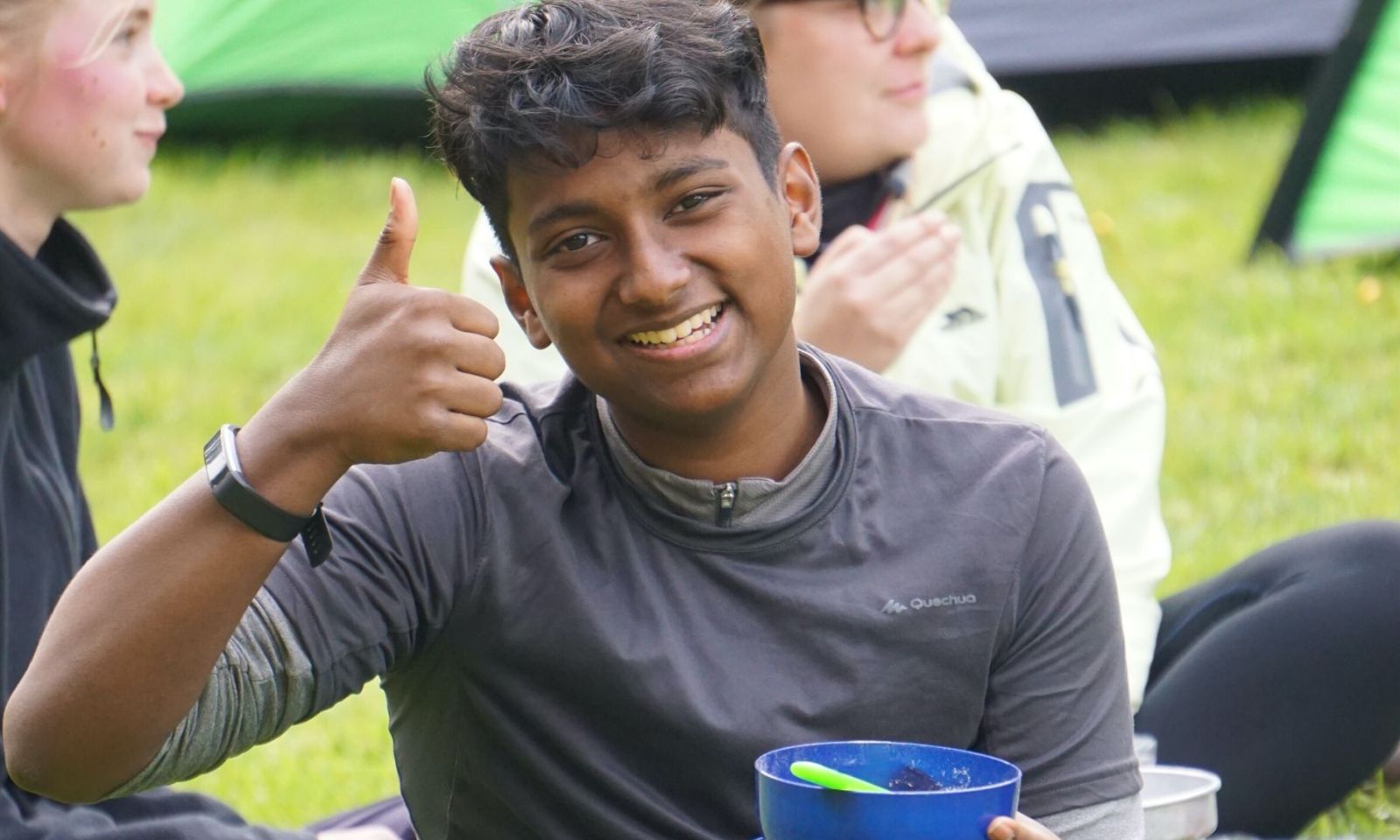 Young man on DofE giving thumbs up and big smile.