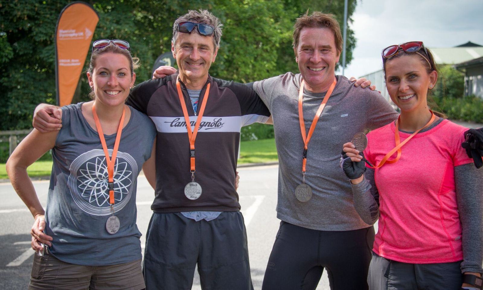 group of 4 people at the end of a charity challenge event.