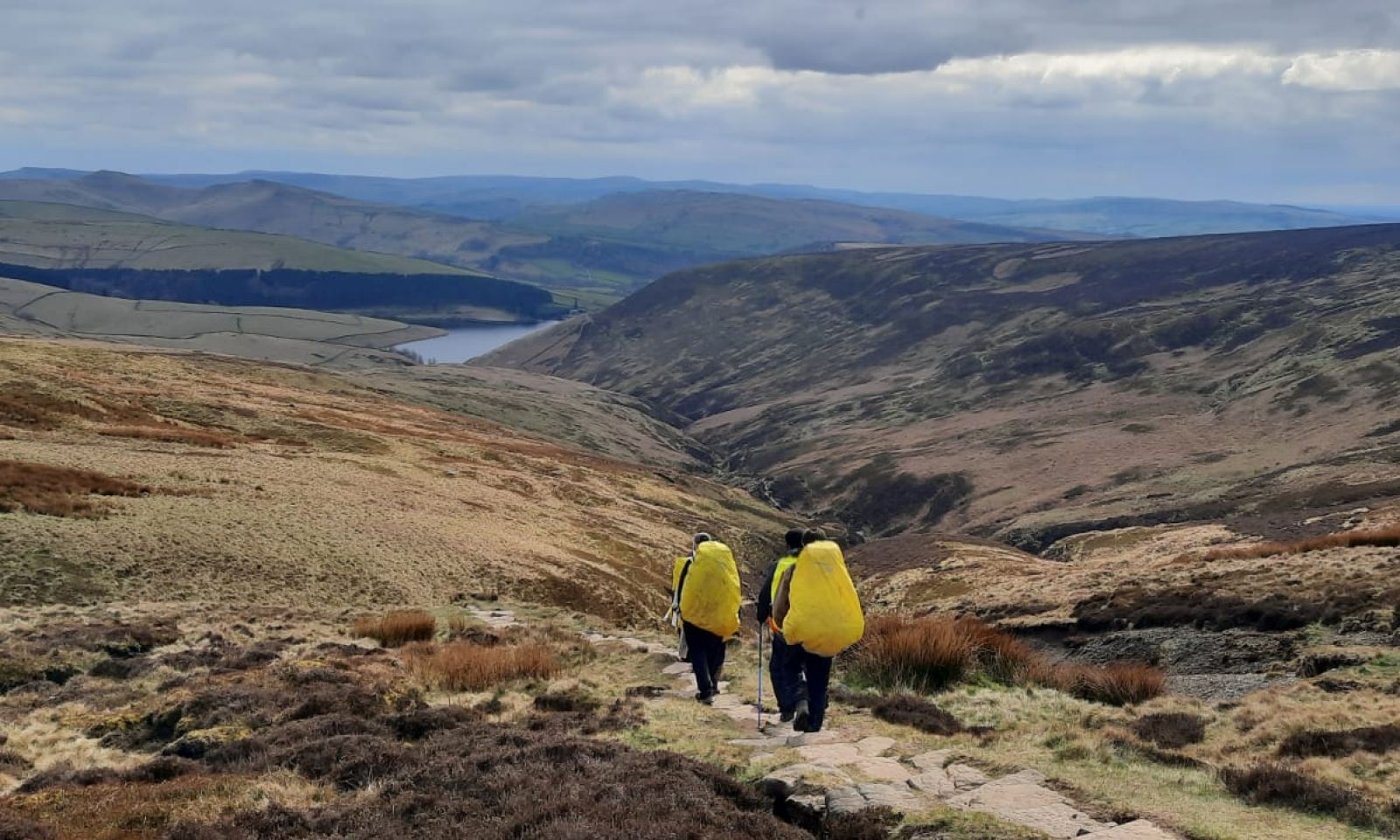Group of silver DofE students walking with rucksacks in the Peak District